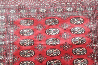 Lot 833 - Lahore Bukhara Rug, the claret field with...