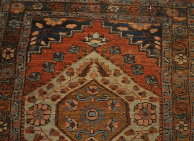 Lot 811 - A narrow Heriz runner, the teracotta field...