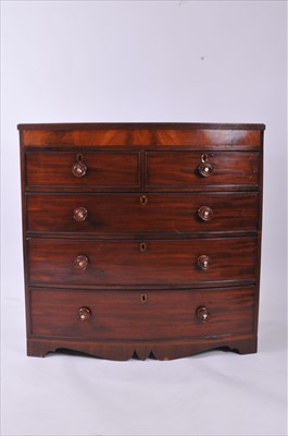 Lot 638 - A mahogany bow-fronted chest of two long and three long drawers