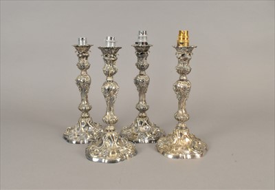 Lot 48 - A set of four Rococo style silver plated candlestick lamps