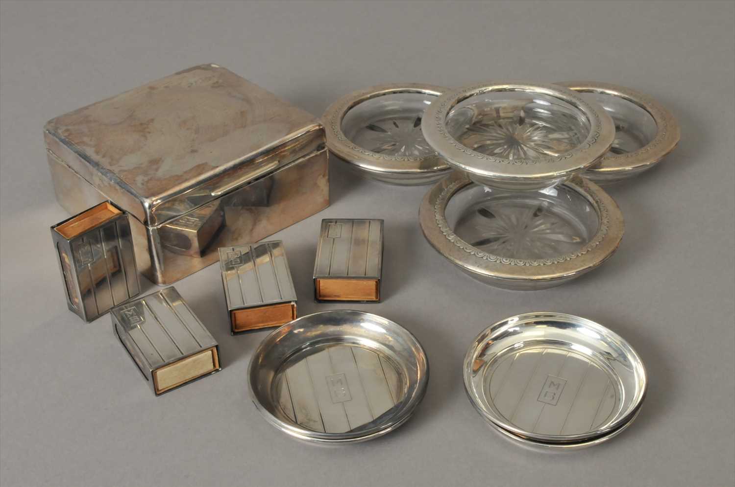 Lot 1 - Four match box holders, together with four white metal mounted glass ash trays, a silver mounted cigar box and four ash trays