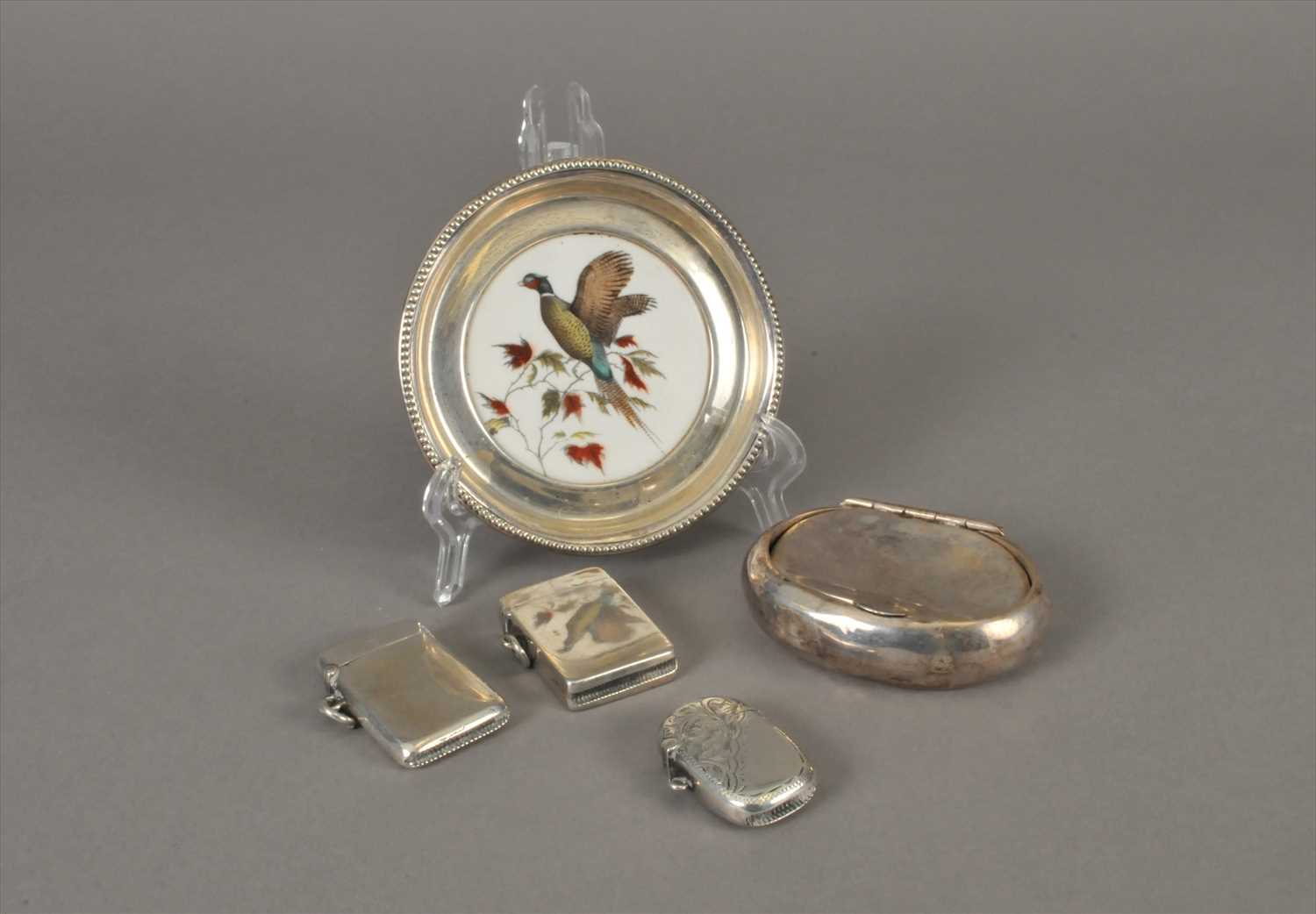 Lot 4 - Three silver vesta cases, a white metal mounted ceramic dish and a silver tobacco box