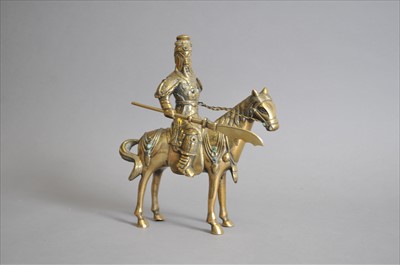 Lot 662 - A brass figure of horse in set with stones and small temple lion