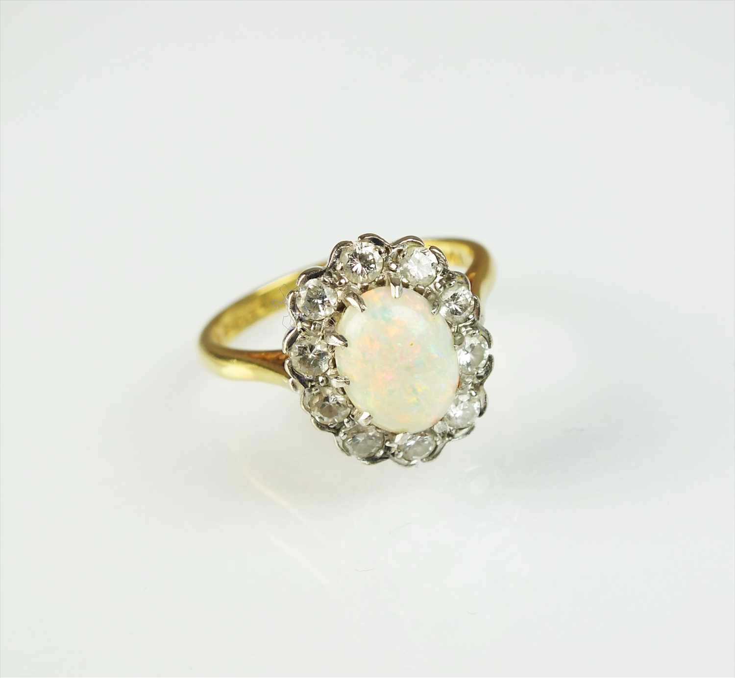 Lot 94 - An 18ct gold opal and diamond cluster ring