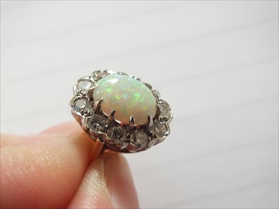 Lot 94 - An 18ct gold opal and diamond cluster ring