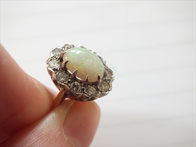 Lot 94 - An 18ct gold opal and diamond cluster ring