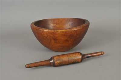 Lot 465 - An Edwardian or earlier treen dairy bowl and a treen roller (2)