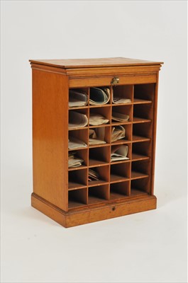 Lot 587 - A small early 20th century pale oak tambour-fronted bank of 24 pigeon holes
