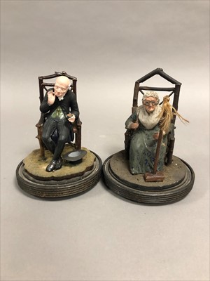 Lot 197 - A pair of late Victorian hand painted plaster figures under clear glass domes