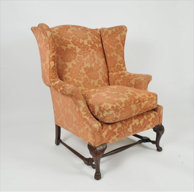 Lot 646 - A George III style wing-back arm chair