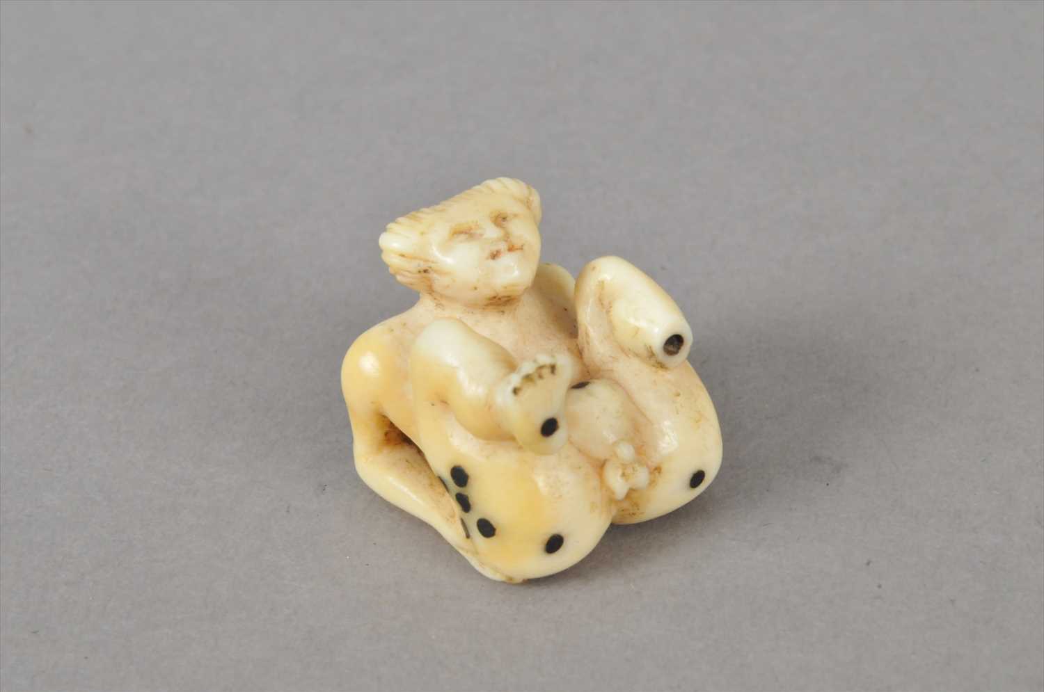 Lot 492 - A small Japanese Meiji period carved ivory erotic figural ivory dice