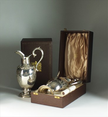 Lot 14 - A pair of Garrards commemorative silver claret jugs