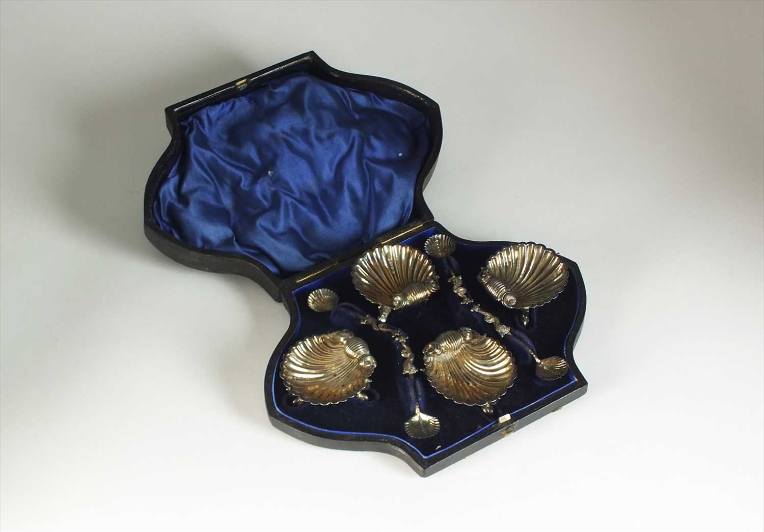 Lot 26 - A cased set of four Victorian shell salts and spoons