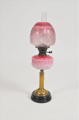 Lot 338 - A Victorian oil lamp with cranberry glass shade