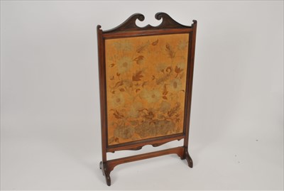 Lot 381 - An Edwardian mahogany framed embroidered fire screen