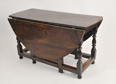 Lot 591 - A 19th century or earlier country oak gateleg dining table
