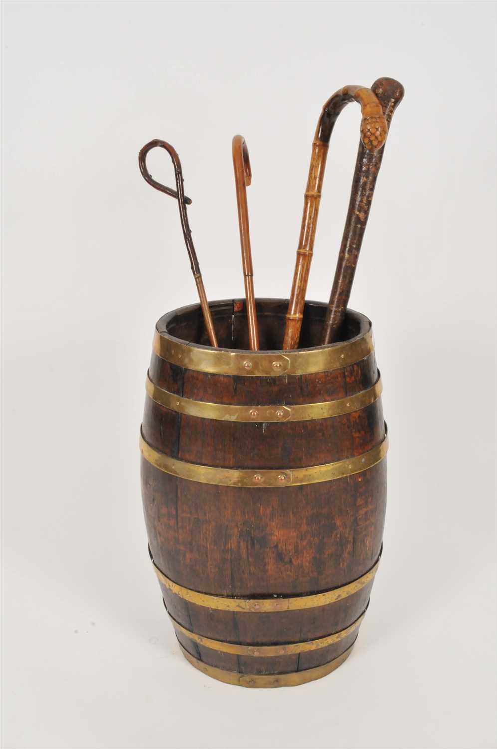 Lot 552 - A Victorian coopered oak barrel / stick stand and several walking canes