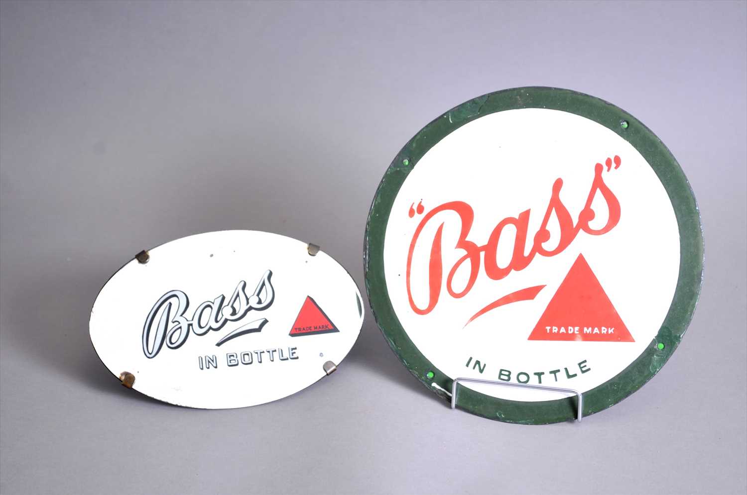 Lot 621 - A small original circular enamel " Bass" in bottle advertising sign and a Bass mirror