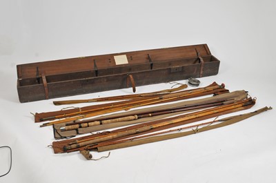 Lot 297 - A large early 20th century hinged pine rod case containing several fishing rods