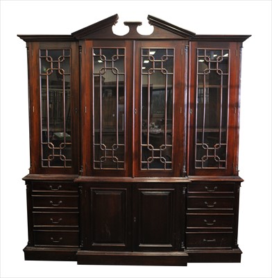 Lot 624 - A large stained reproduction breakfront bookcase