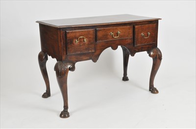 Lot 321 - A George II style oak lowboy