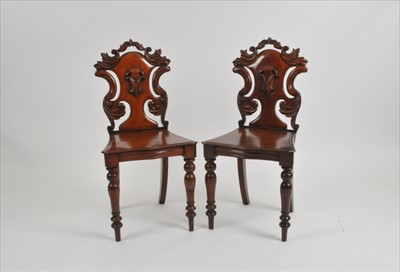 Lot 584 - A pair of Victorian mahogany hall chairs