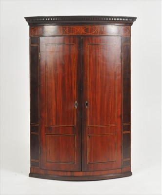 Lot 361 - A 19th century mahogany veneered bow-fronted corner cupboard