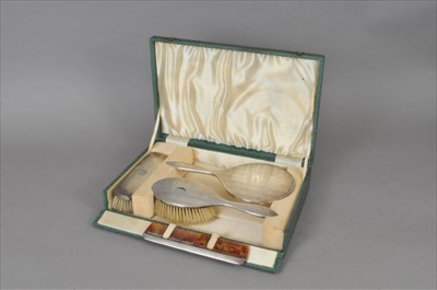 Lot 37 - A cased silver mounted dressing table set