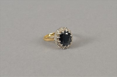 Lot 76 - A sapphire and diamond cluster ring