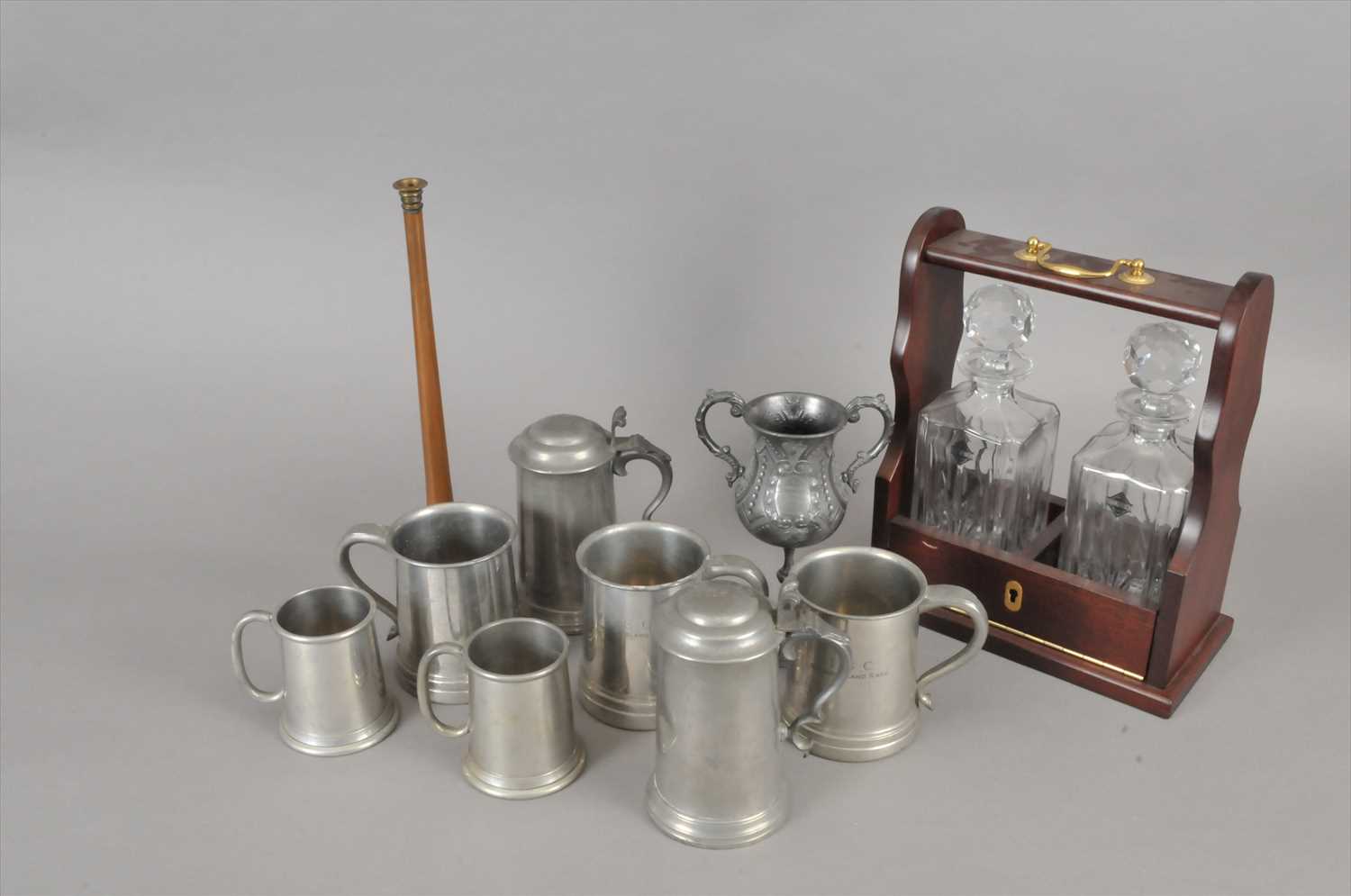 Lot 216 - A small collection of antique pewter tankards and a reproduction two decanter Tantalus.