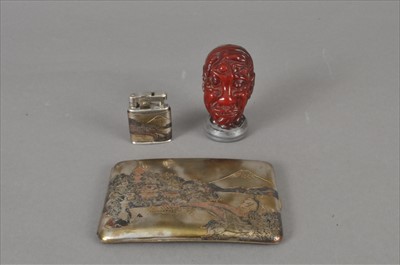 Lot 236 - A small cased Japanese cigarette case and lighter duo and a simulated amber head