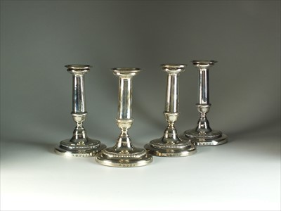 Lot 3 - A set of four George III silver candlesticks