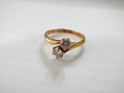 Lot 55 - A two stone diamond cross over ring