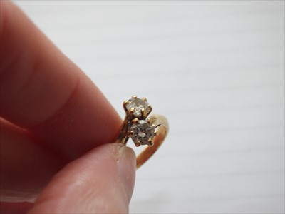 Lot 55 - A two stone diamond cross over ring