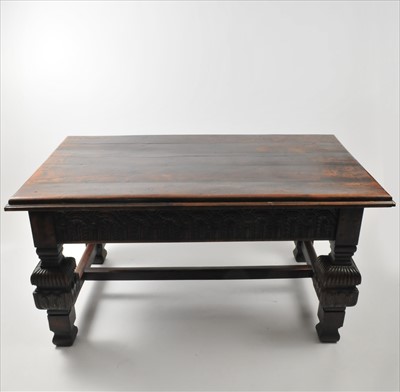 Lot 373 - A heavy rustic oak dining table