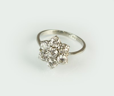 Lot 59 - A platinum seven stone diamond floral cluster ring