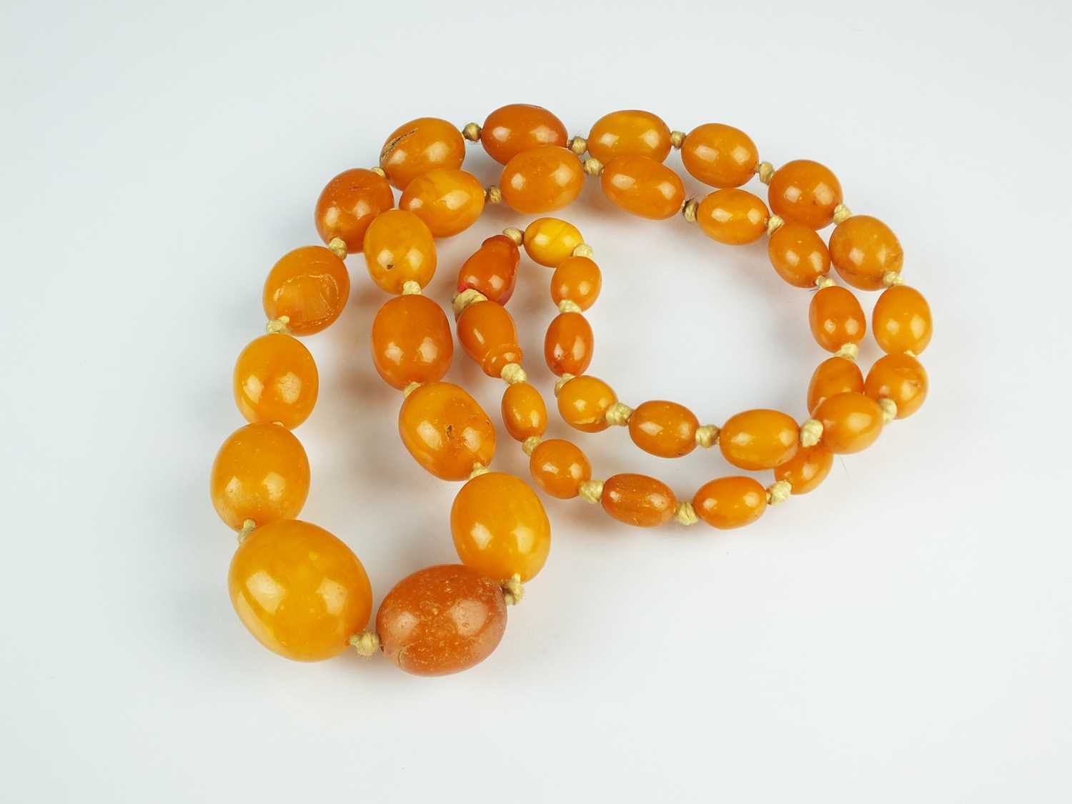 Lot 68 - A graduated amber bead necklace