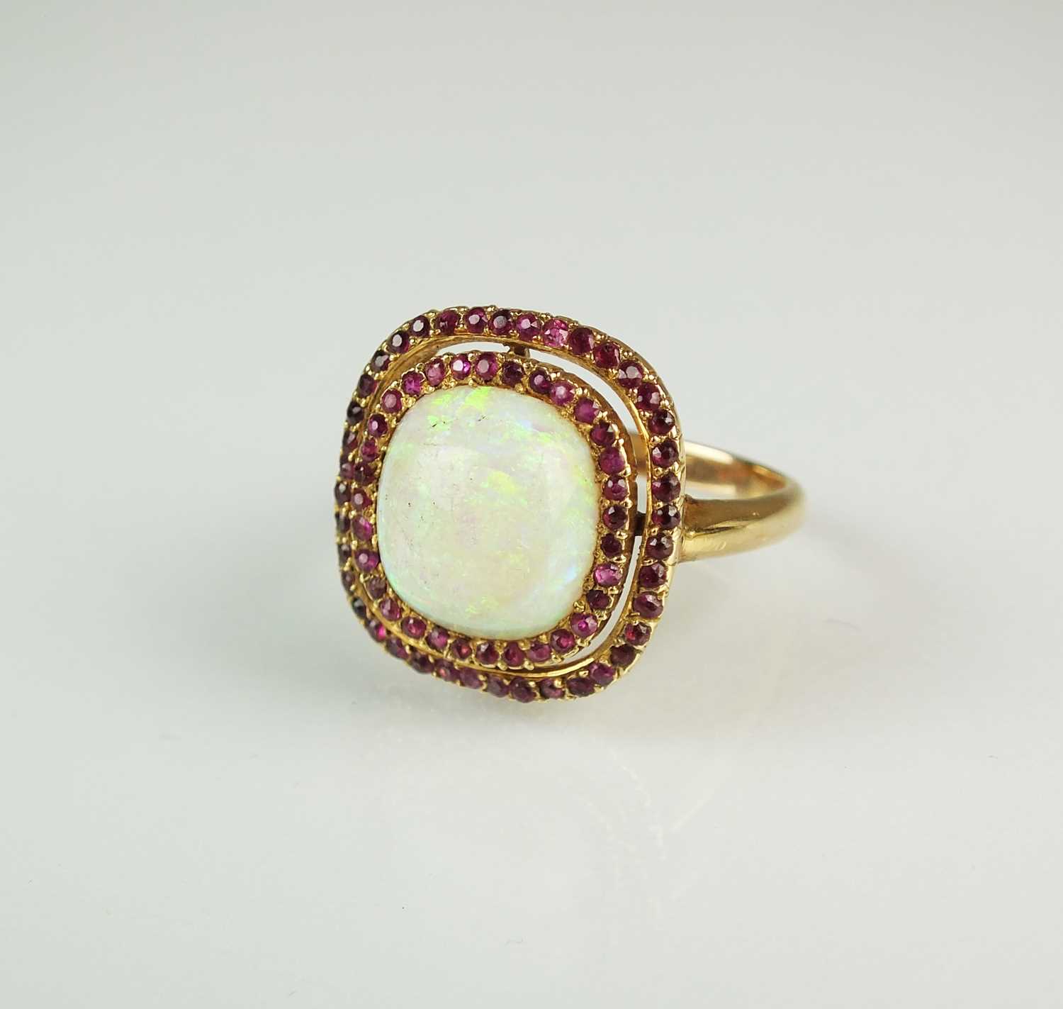 Lot 69 - A ruby and opal cluster ring