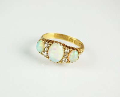 Lot 76 - An Edwardian nine stone opal and diamond ring