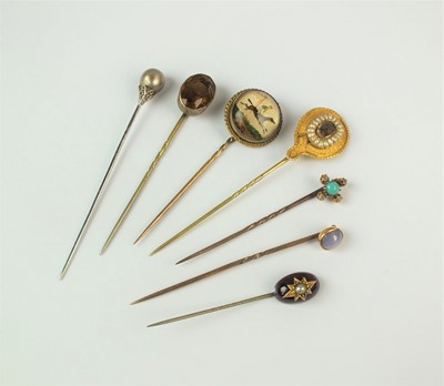 Lot 131 - A collection of seven stick pins