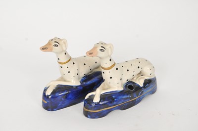 Lot 141 - Two Staffordshire dalmatian quill holders on...