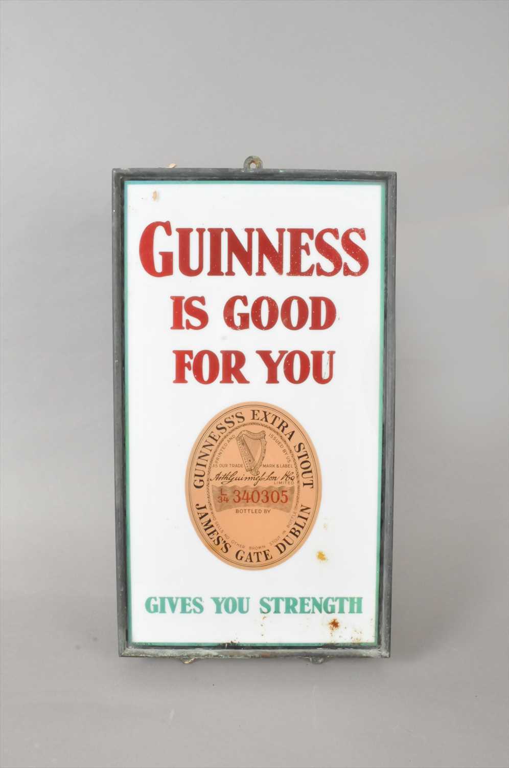 Lot 635 - An original 20th century glazed enamel pub sign advertising Guinness