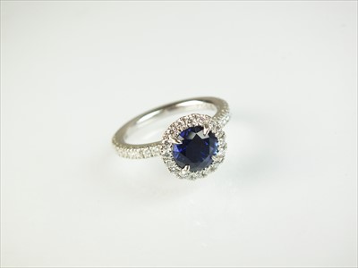 Lot 110 - A sapphire and diamond cluster ring