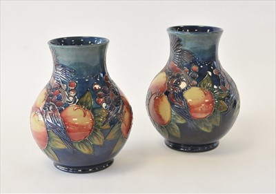 Lot 91 - A pair of Moorcroft 'Finches Pecking Fruit' vases