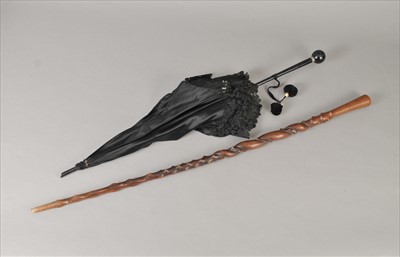 Lot 272 - An Indian carved hardwood cane and a black silk Paragon parasol