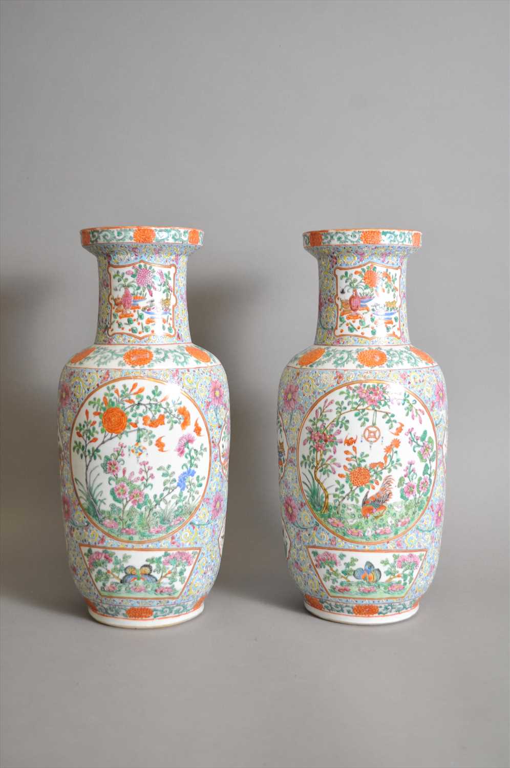 Lot 669 - A pair of Chinese porcelain famille rose turquoise ground baluster vases, Qing dynasty