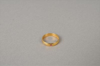 Lot 369 - A 22ct gold ruby and diamond set band