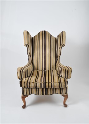 Lot 542 - An early 20th century wing armchair with...