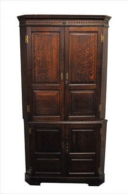 Lot 416 - A large George III free-standing two sectional corner cupboard