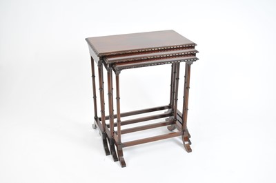 Lot 398 - A graduated mahogany trio of nesting occasional tables